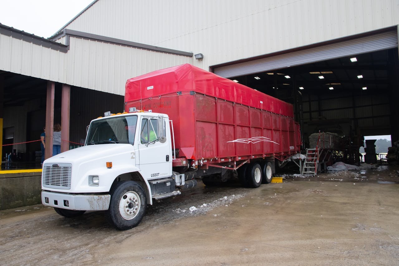 Truck with Red Trailer Near Warehouse